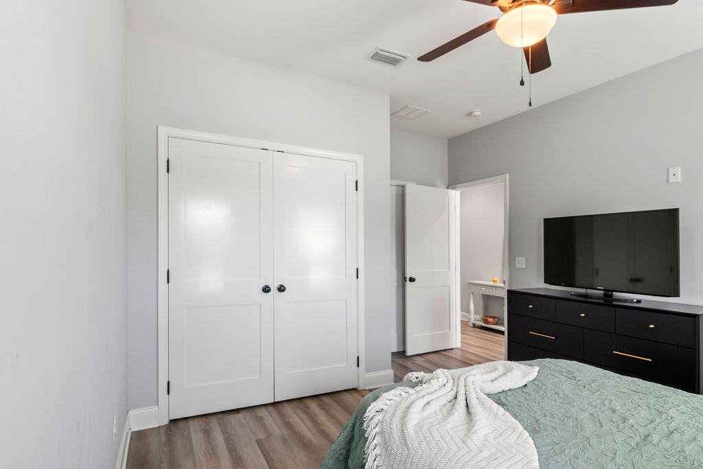 57 5th Street Shalimar, FL 32579 - Photo 12 of 31 a bedroom with a bed and a flat screen tv