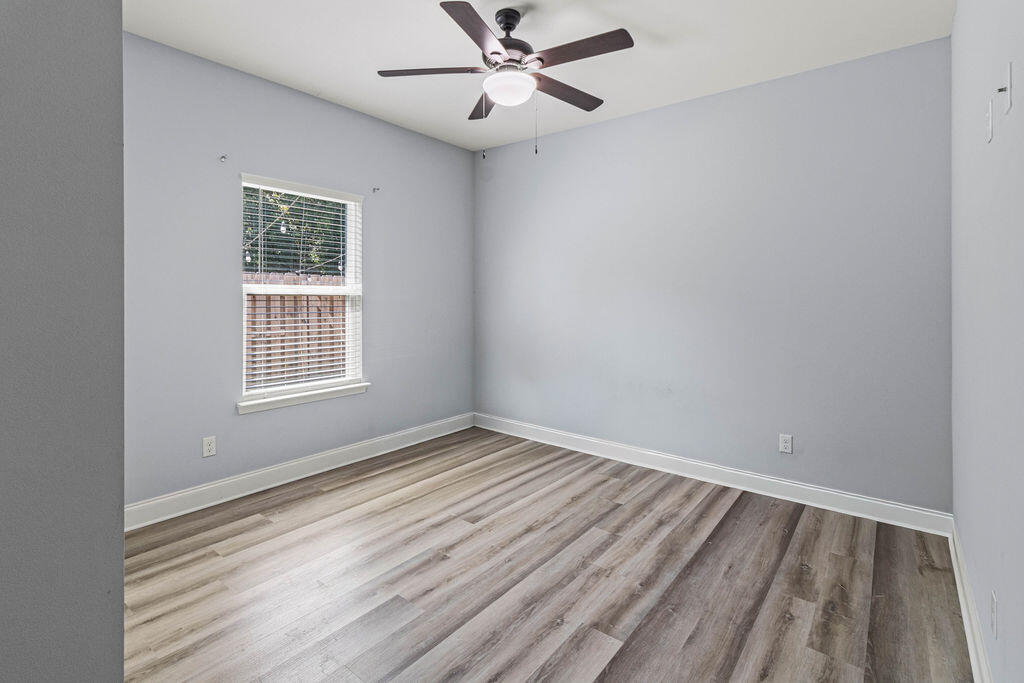 57 5th Street Shalimar, FL 32579 - Photo 13 of 30 wooden floor in an empty room with a window