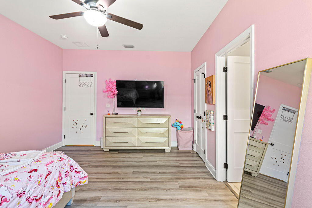 57 5th Street Shalimar, FL 32579 - Photo 16 of 30 a bedroom with a bed and a flat screen tv