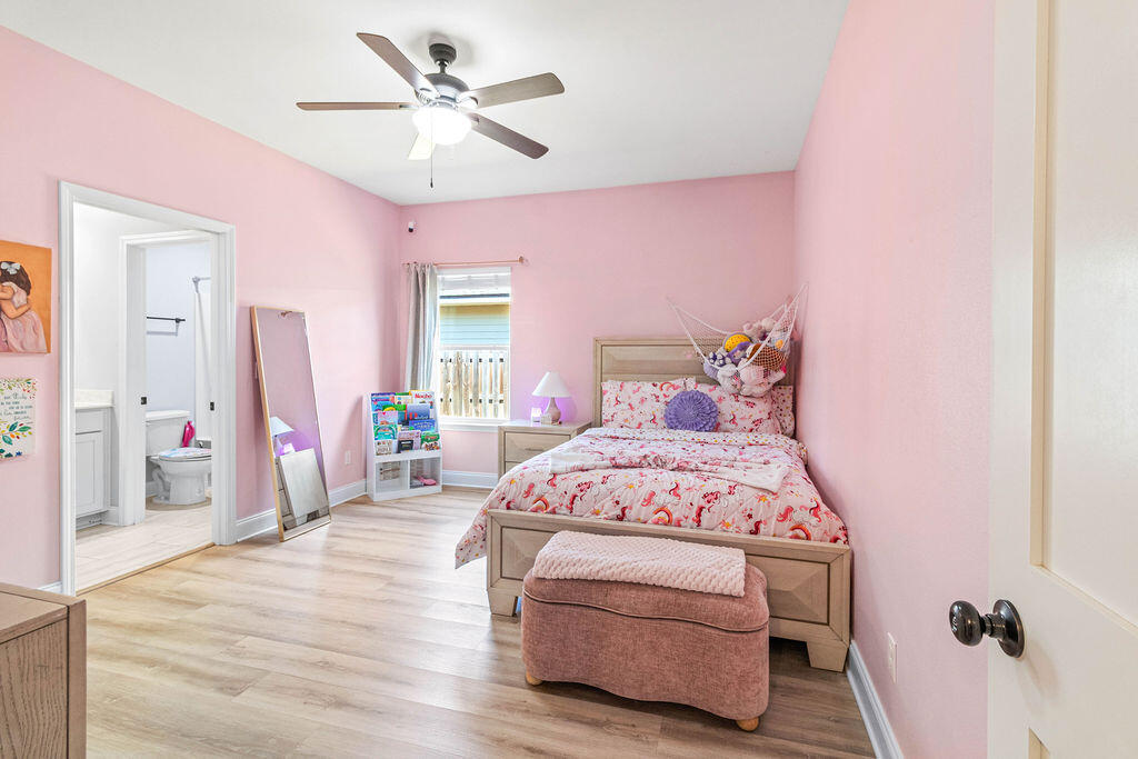 57 5th Street Shalimar, FL 32579 - Photo 17 of 31 a bedroom with a bed and a chandelier