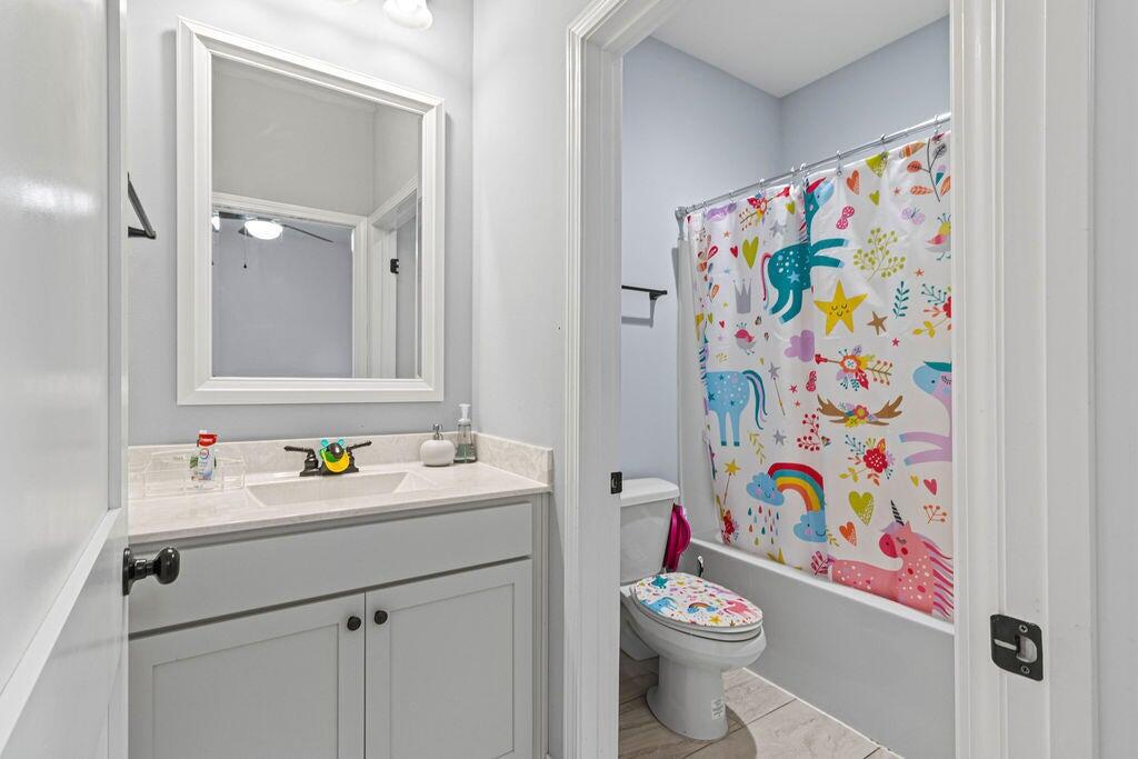 57 5th Street Shalimar, FL 32579 - Photo 17 of 30 a bathroom with a sink mirror and toilet
