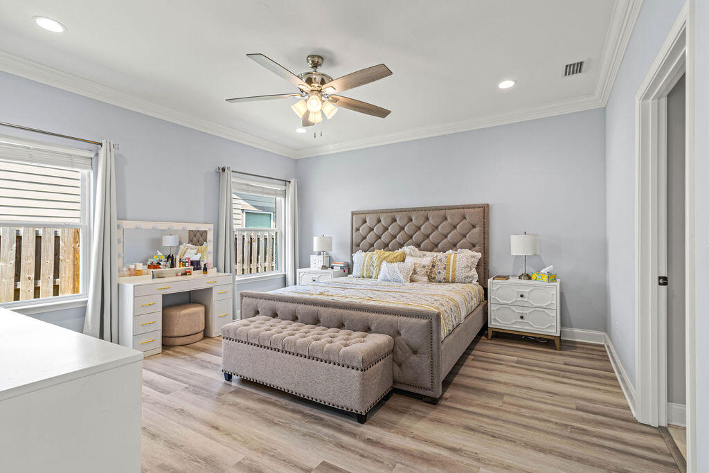 57 5th Street Shalimar, FL 32579 - Photo 18 of 30 a bedroom with a large bed and a chandelier