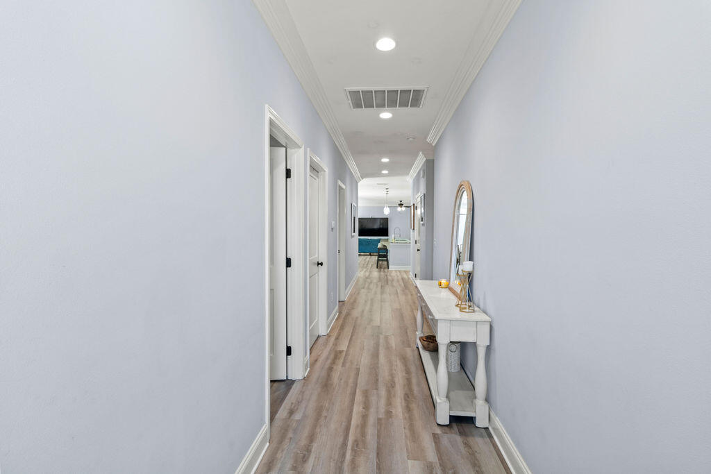 57 5th Street Shalimar, FL 32579 - Photo 2 of 30 a view of a hallway with wooden floor and staircase