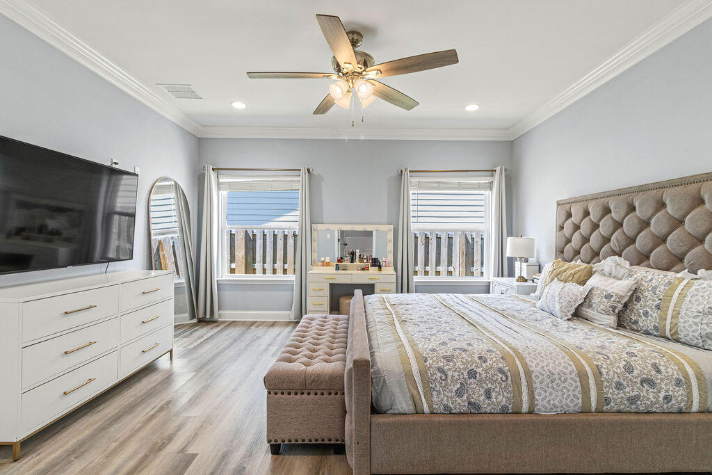 57 5th Street Shalimar, FL 32579 - Photo 21 of 31 a bedroom with a large bed a flat tv screen and dresser