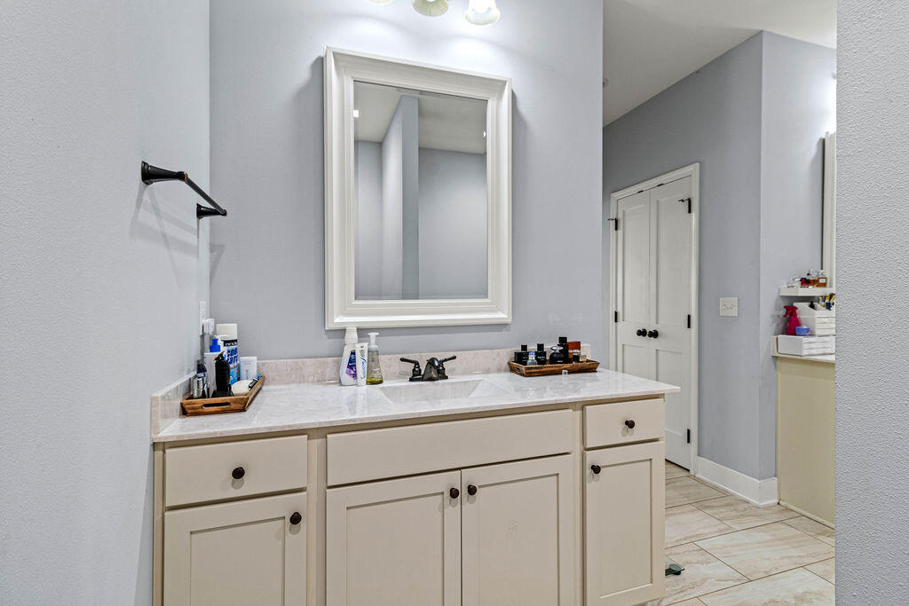57 5th Street Shalimar, FL 32579 - Photo 23 of 30 a bathroom with a sink and a mirror