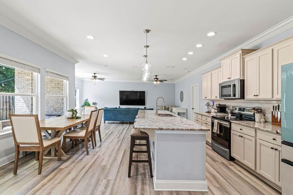 57 5th Street Shalimar, FL 32579 - Photo 6 of 31 a large kitchen with a table and chairs in it