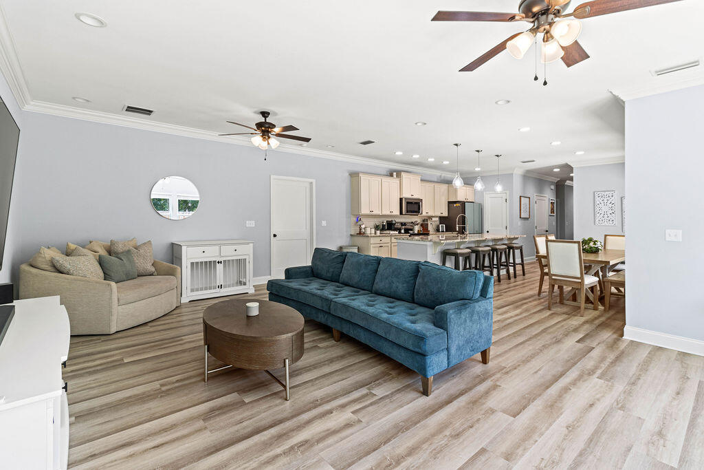 57 5th Street Shalimar, FL 32579 - Photo 7 of 30 a living room with furniture a ceiling fan and a rug