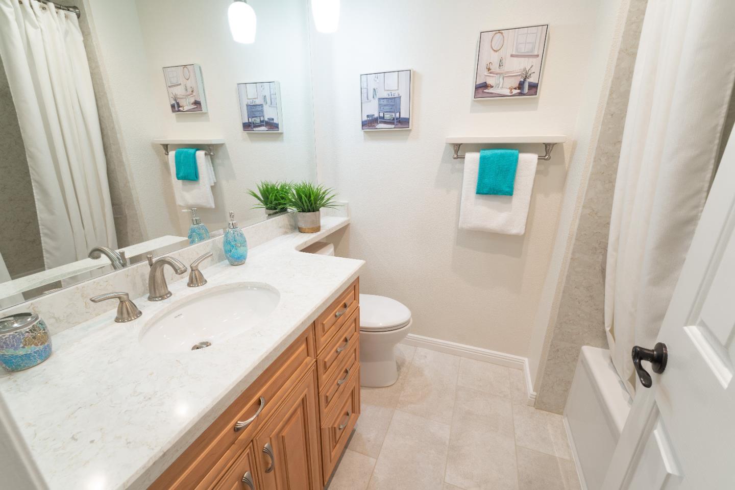 808 Hamilton Avenue Milpitas, CA 95035 - Photo 22 of 41 a bathroom with a sink a toilet and shower curtain