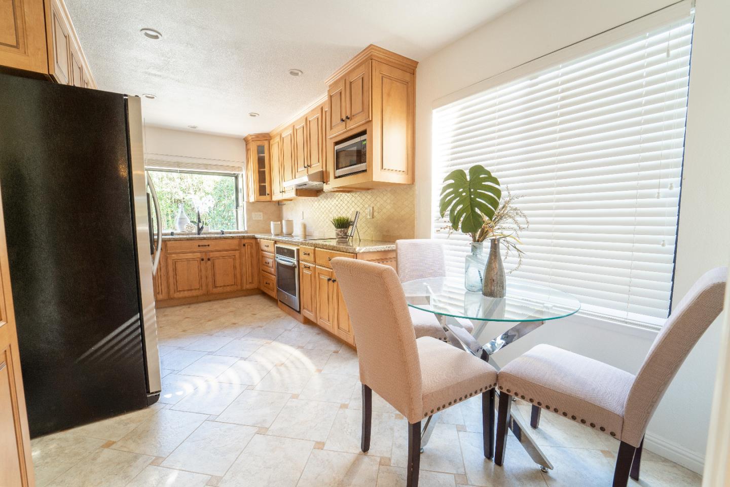 808 Hamilton Avenue Milpitas, CA 95035 - Photo 8 of 41 a kitchen with stainless steel appliances granite countertop a dining table chairs and a refrigerator