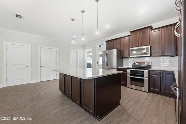 a kitchen with stainless steel appliances granite countertop a sink and a granite counter tops