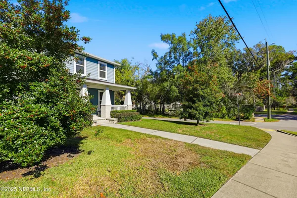an aerial view of a house with a yard