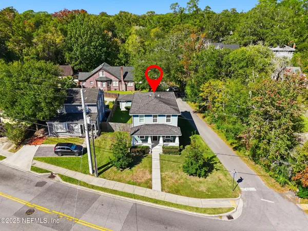 an aerial view of a house with a yard