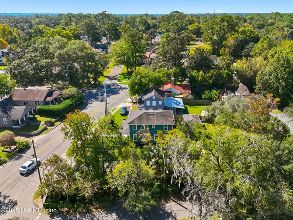 an aerial view of residential houses with outdoor space