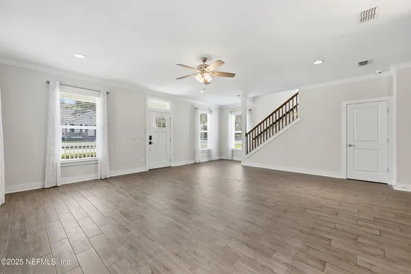 a kitchen with stainless steel appliances granite countertop a refrigerator a sink dishwasher a oven with a dining table and chairs