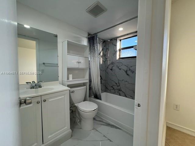 8075 Northwest 7th Street, Unit 501 Miami, FL 33126 - Photo 17 of 28 a bathroom with a granite countertop sink toilet and shower