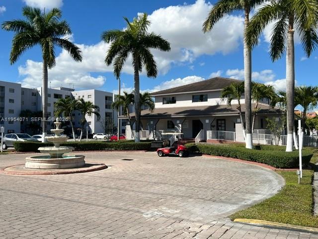 8075 Northwest 7th Street, Unit 501 Miami, FL 33126 - Photo 27 of 28 a view of a street with a building and palm trees