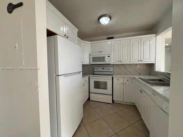 8075 Northwest 7th Street, Unit 501 Miami, FL 33126 - Photo 6 of 28 a kitchen with cabinets stainless steel appliances and a window