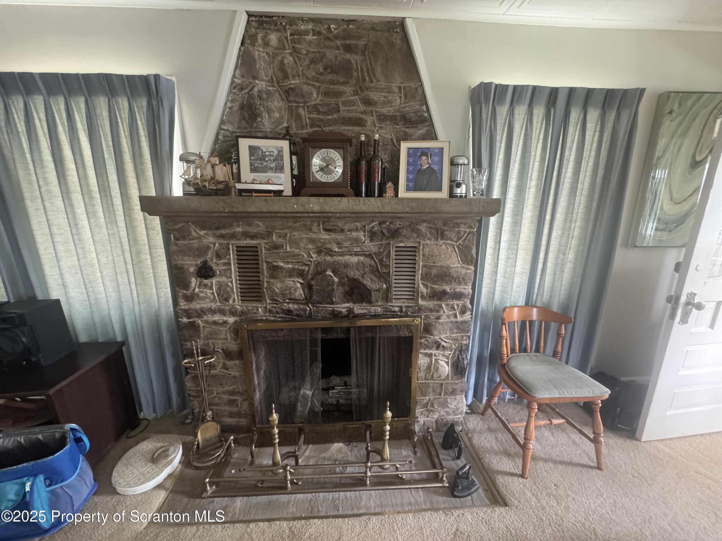 464 Point Road Lake Winola, PA 18419 - Photo 11 of 47 a living room with furniture and a fireplace