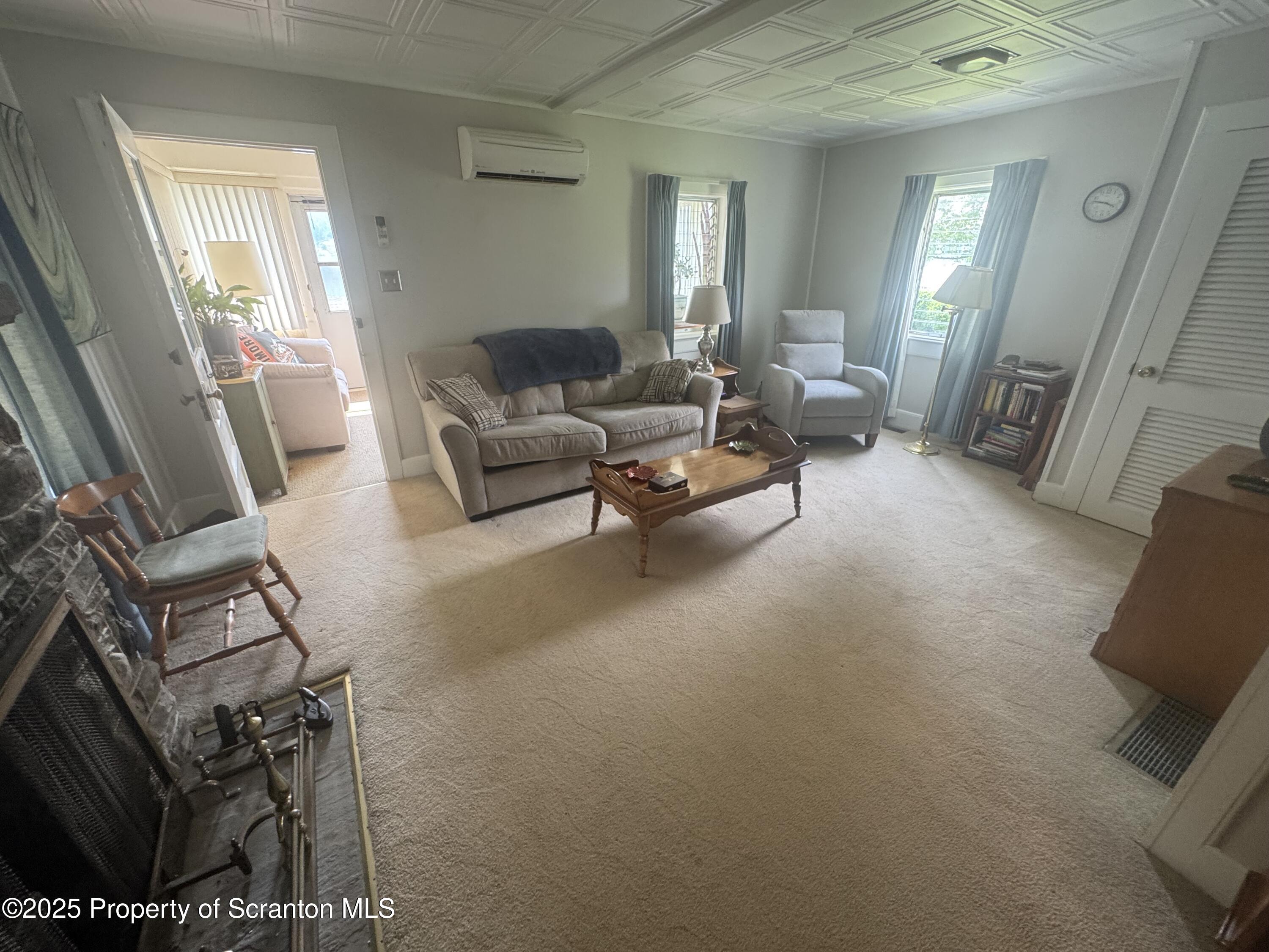 464 Point Road Lake Winola, PA 18419 - Photo 12 of 47 a living room with furniture and a flat screen tv