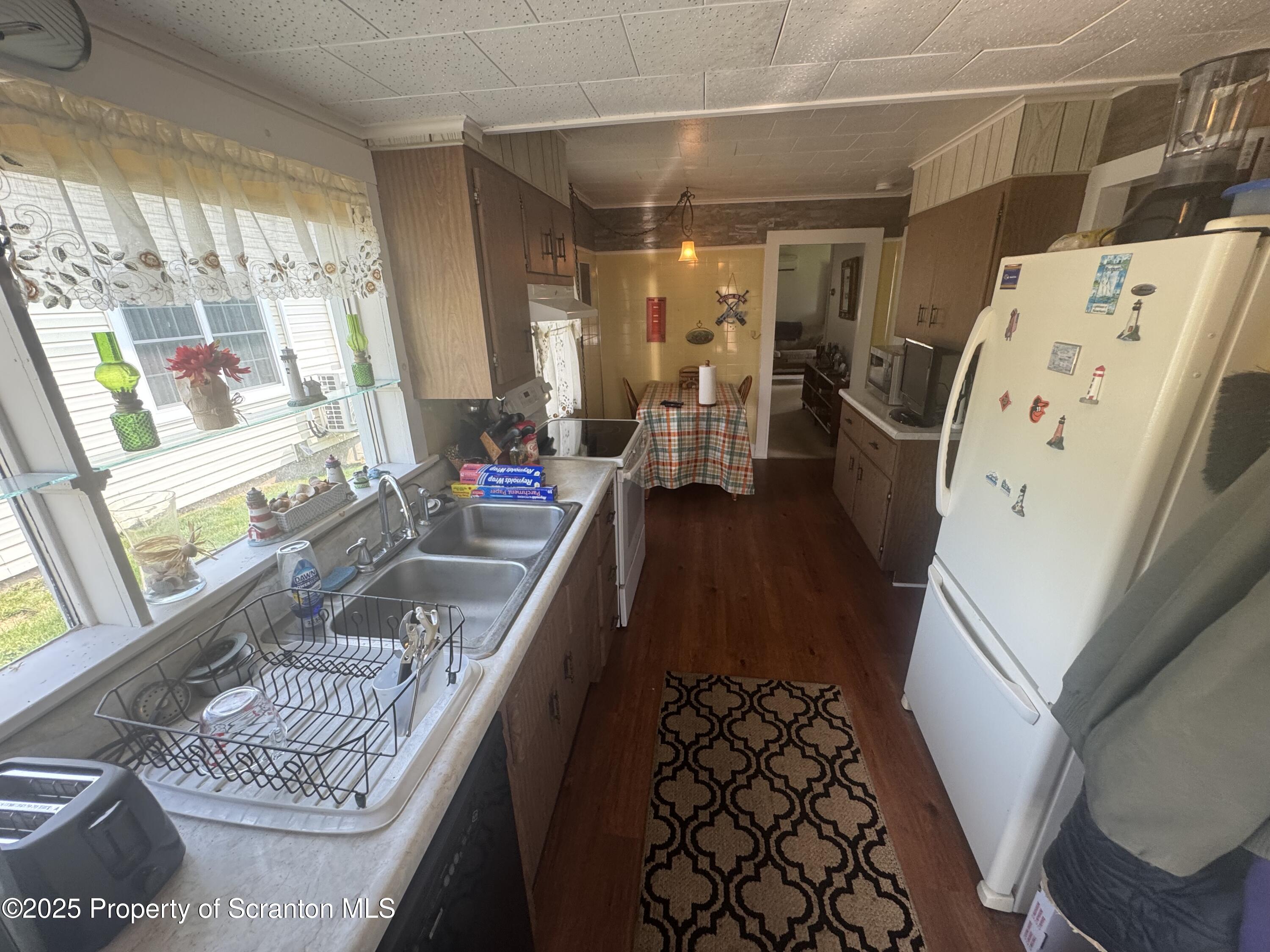 464 Point Road Lake Winola, PA 18419 - Photo 13 of 47 a living room with furniture and a large window