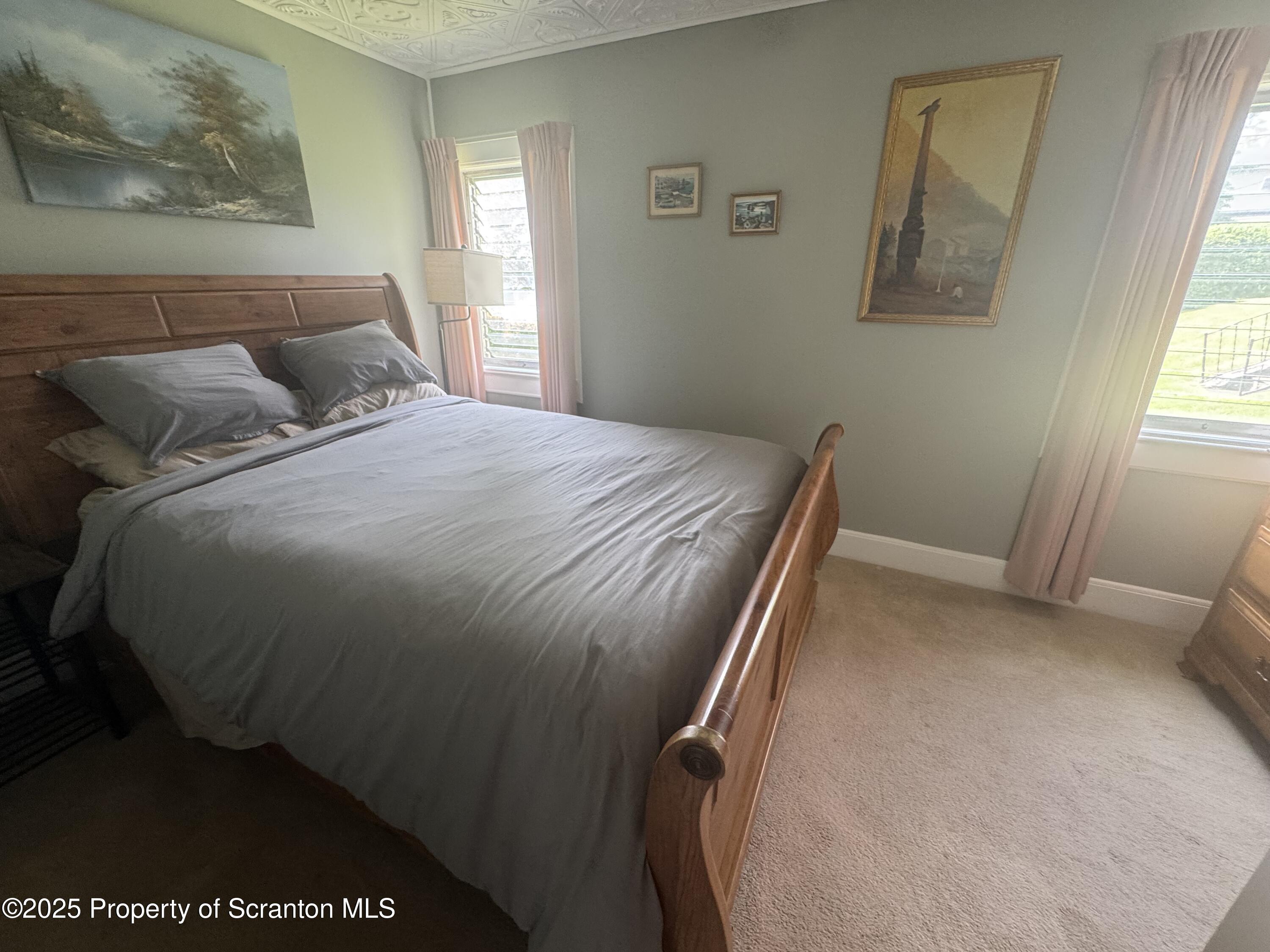 464 Point Road Lake Winola, PA 18419 - Photo 15 of 47 a bedroom with a bed and window