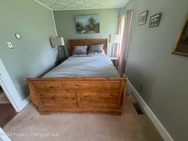 a bed sitting in a bedroom next to a window