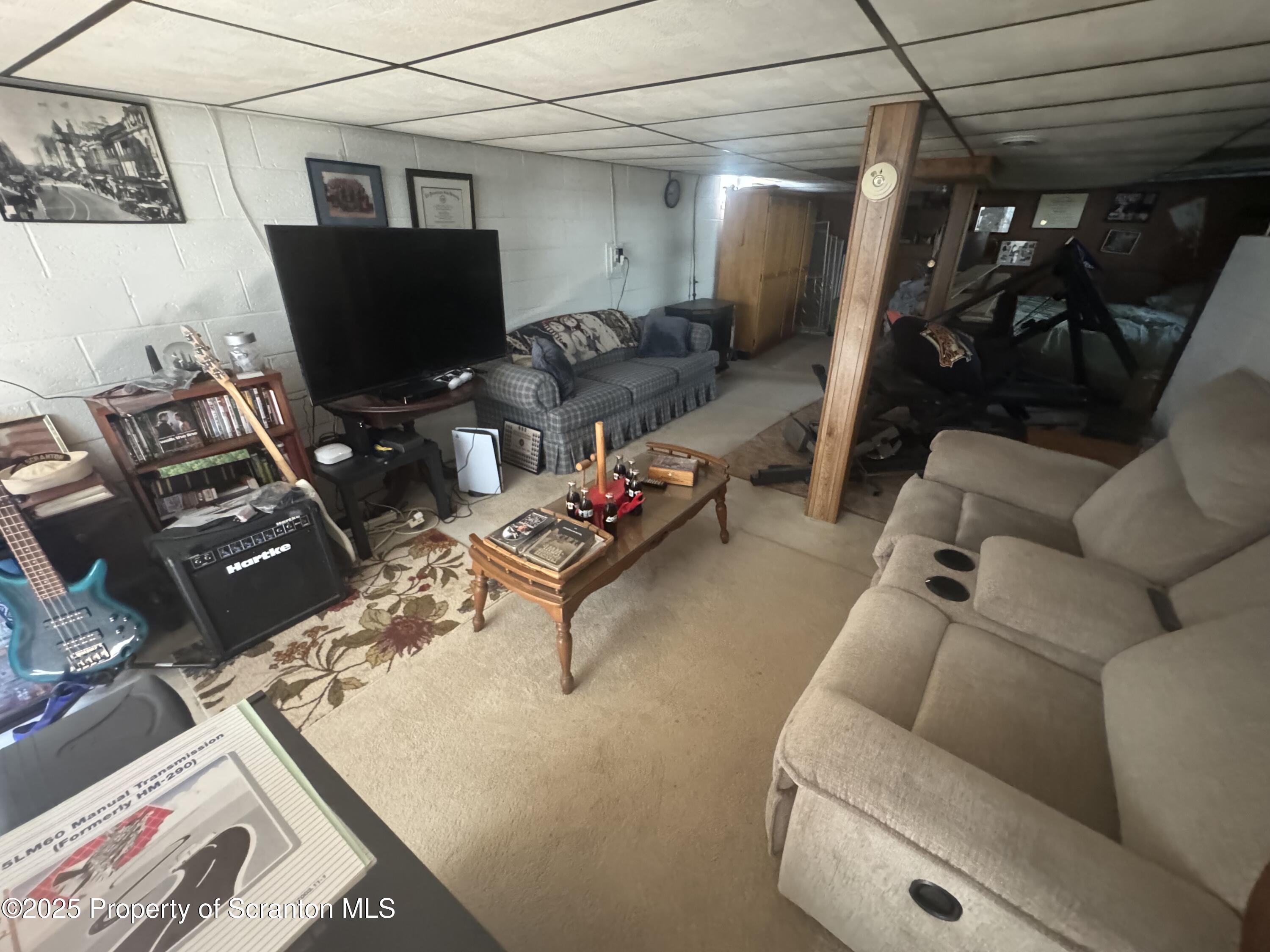 464 Point Road Lake Winola, PA 18419 - Photo 18 of 47 a living room with furniture and a flat screen tv