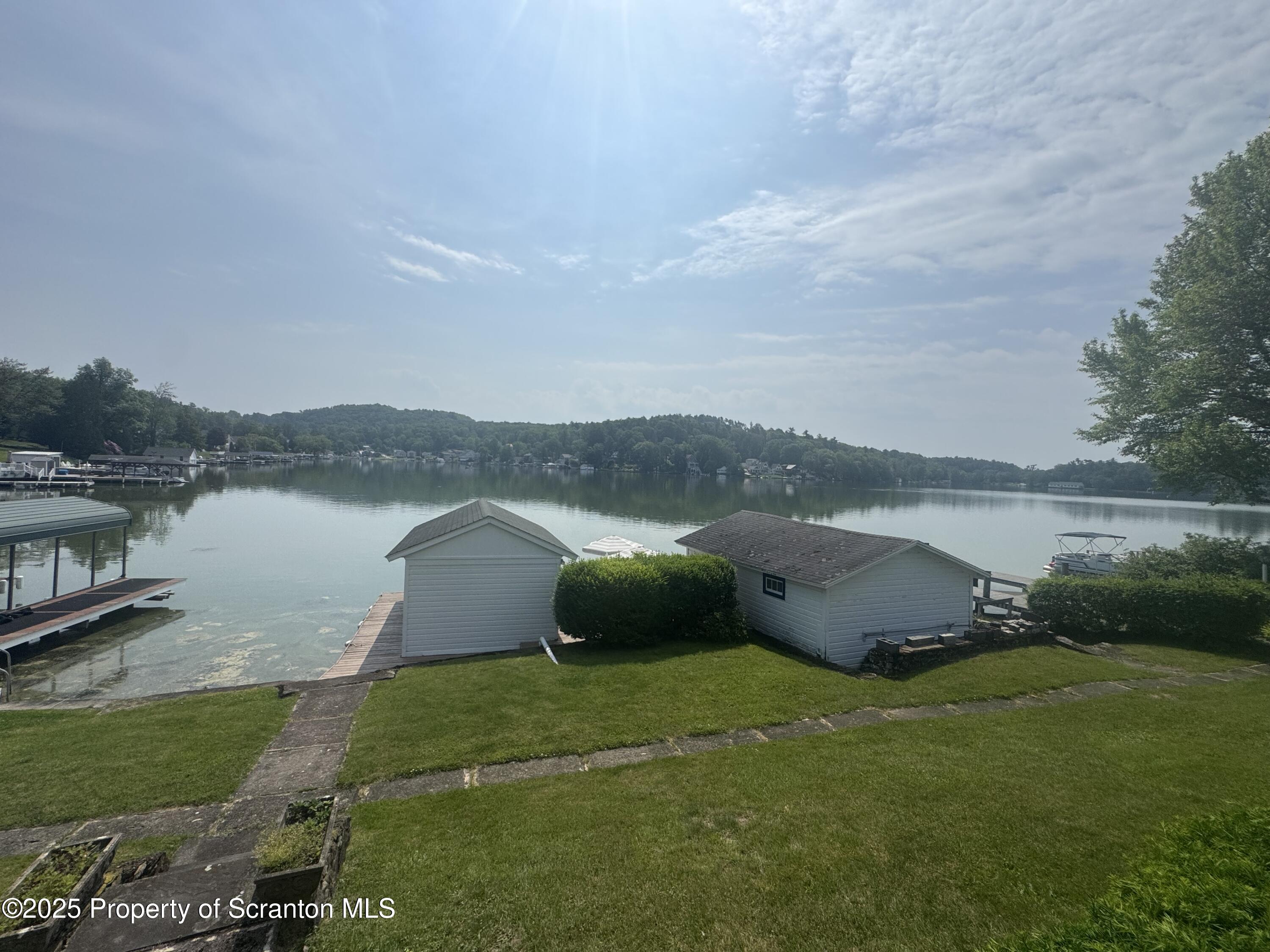 464 Point Road Lake Winola, PA 18419 - Photo 2 of 47 a view of a lake with houses in the background