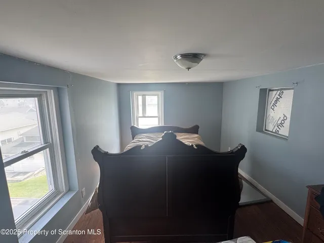 a bed sitting in a bedroom next to a window