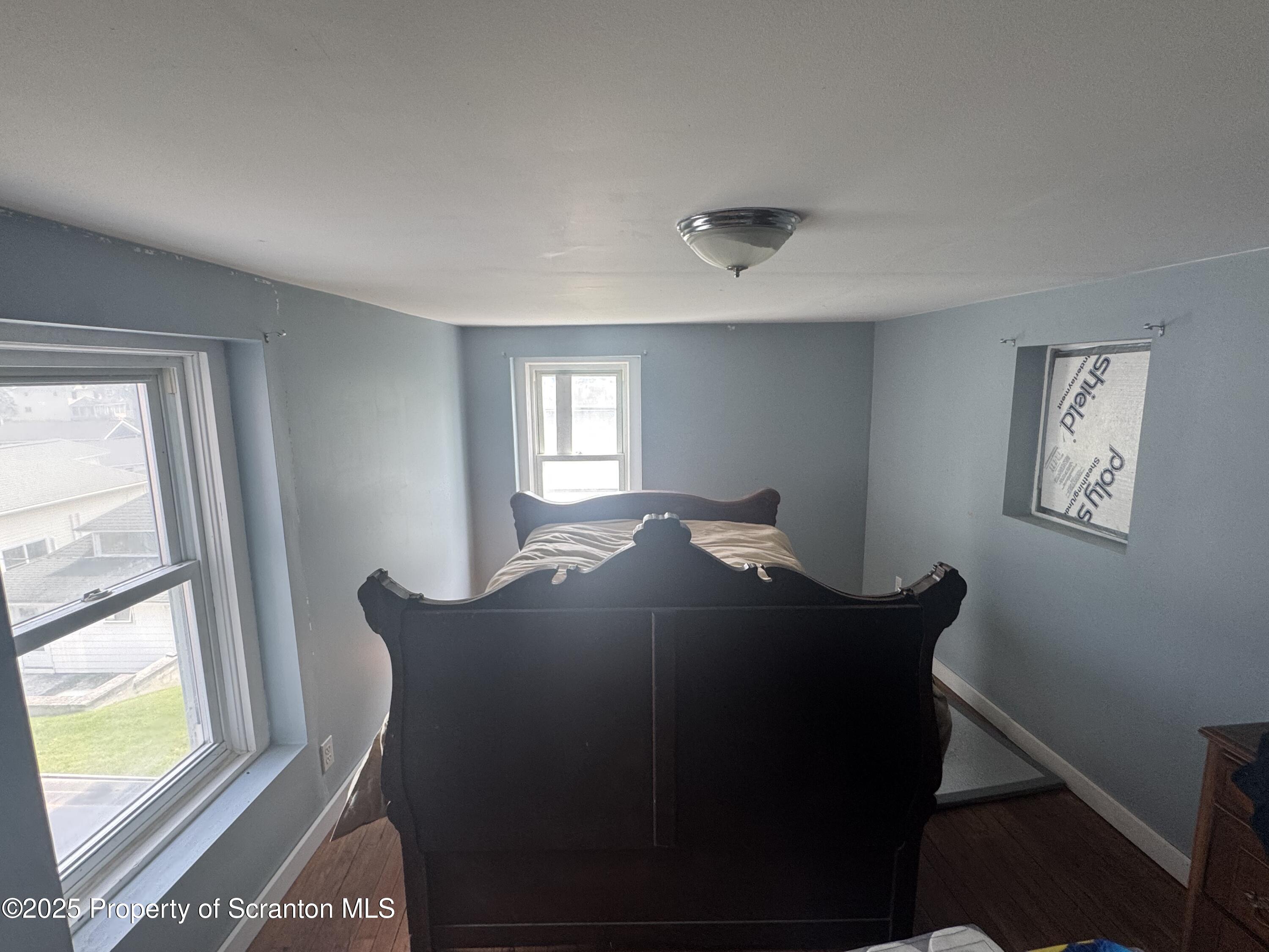 464 Point Road Lake Winola, PA 18419 - Photo 21 of 47 a bed sitting in a bedroom next to a window