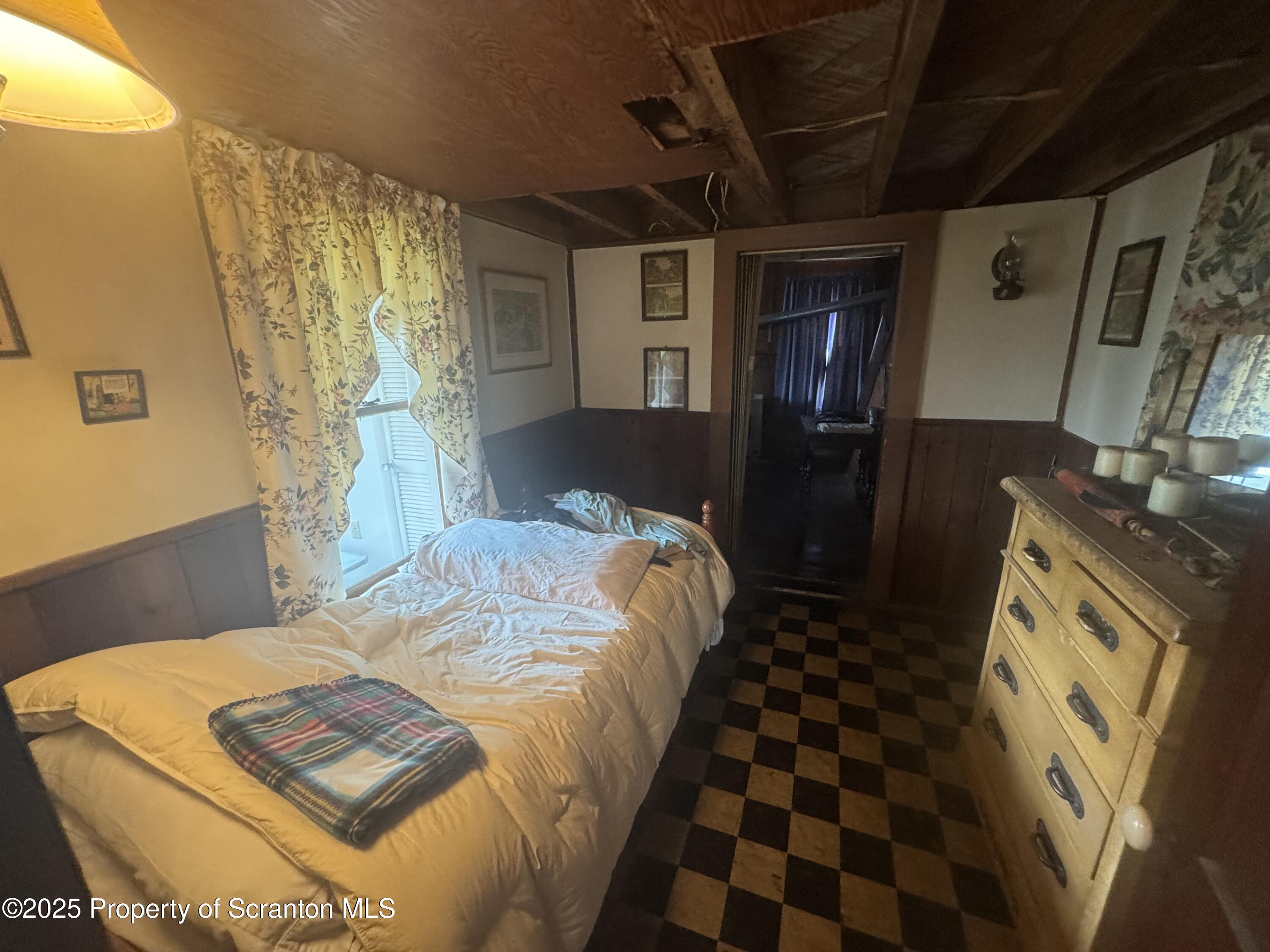 464 Point Road Lake Winola, PA 18419 - Photo 27 of 47 a bed sitting in a bedroom next to a window