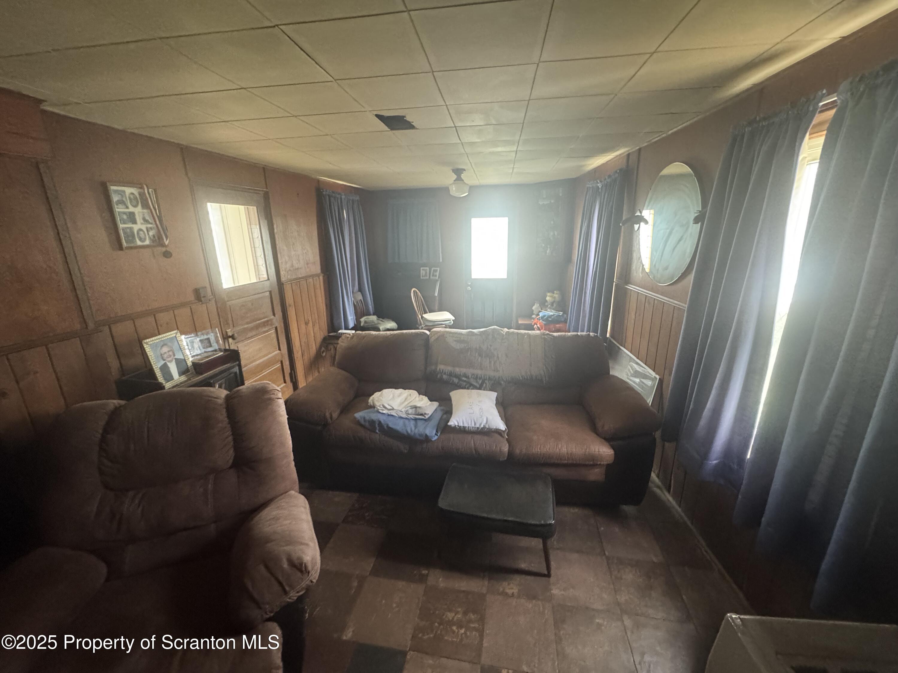 464 Point Road Lake Winola, PA 18419 - Photo 28 of 47 a living room with furniture and a mirror