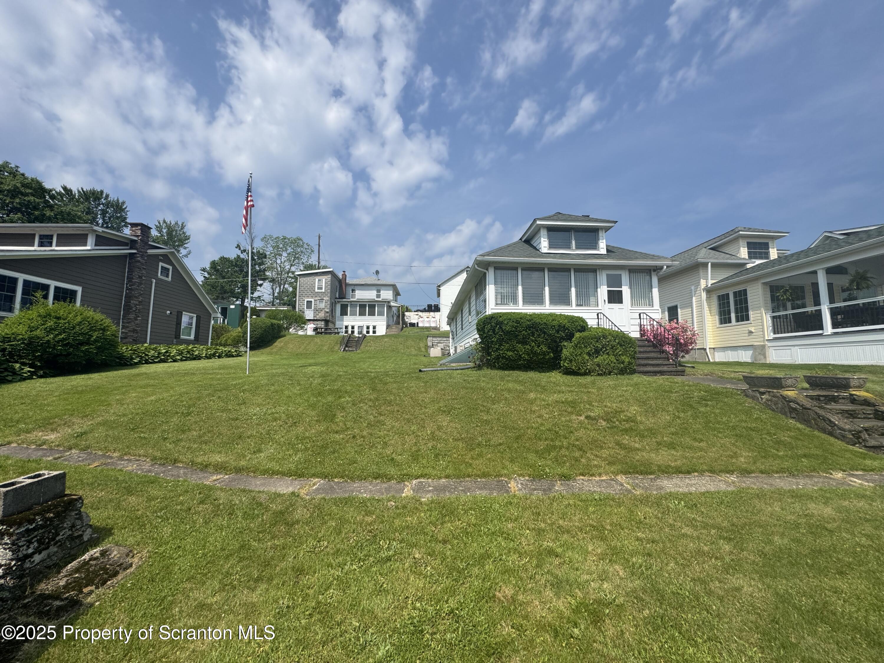 464 Point Road Lake Winola, PA 18419 - Photo 47 of 47 a front view of a house with a yard