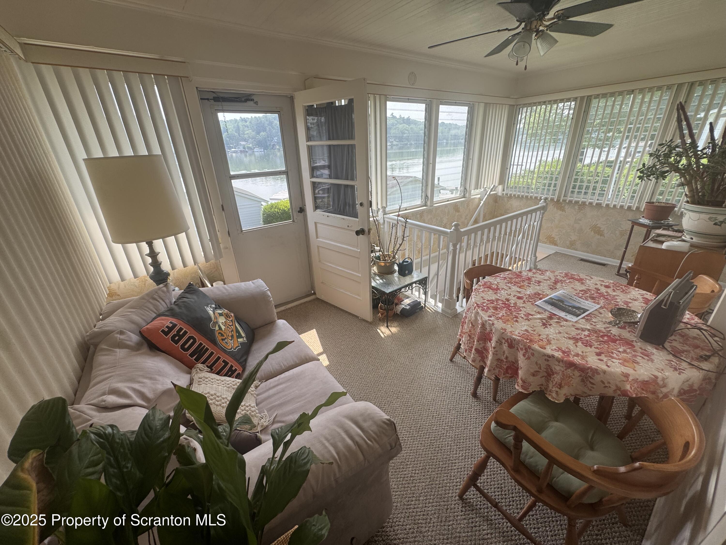 464 Point Road Lake Winola, PA 18419 - Photo 8 of 47 a living room with furniture and floor to ceiling windows