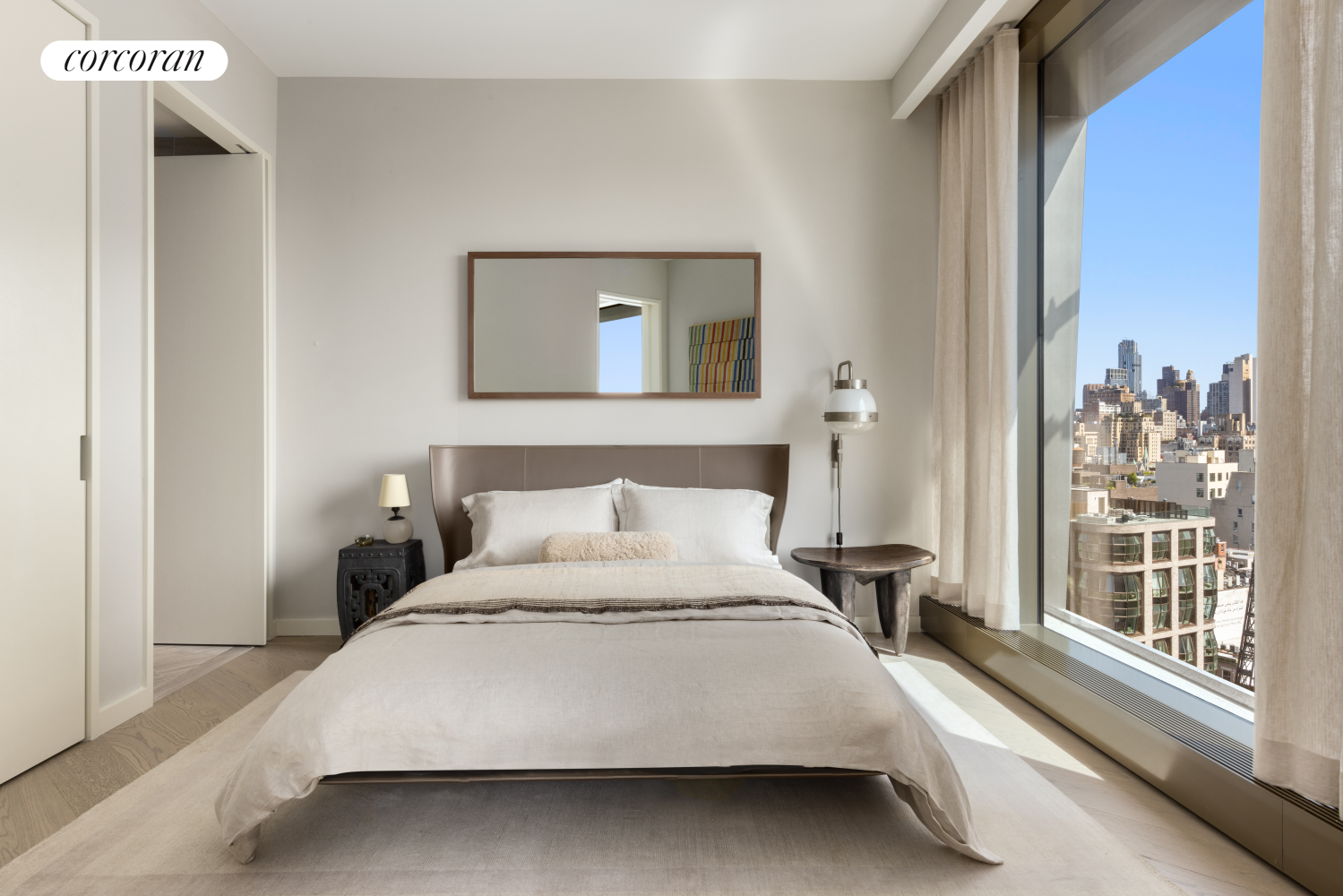 500 West 18th Street, Unit WEST 9F Manhattan, NY 10011 - Photo 5 of 14 a bedroom with a bed and a large mirror next to a window