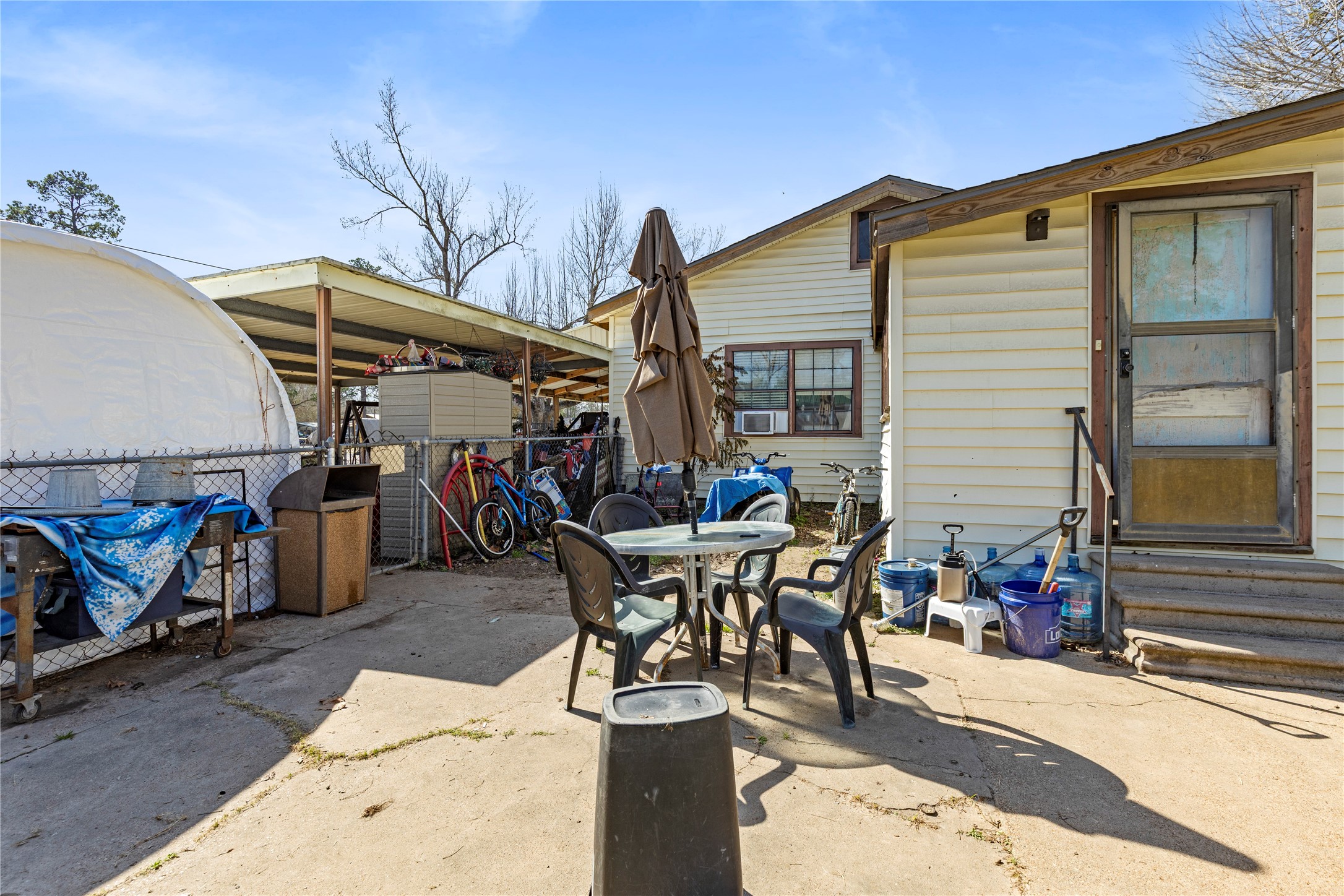 11281 Highway 150 Shepherd, TX 77371 - Photo 22 of 39 a view of a patio with table and chairs and potted plants