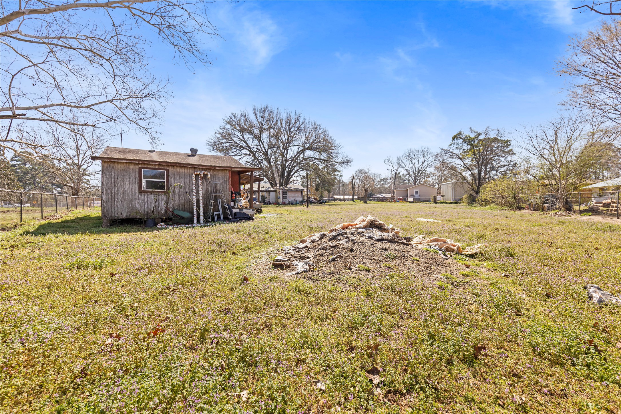 11281 Highway 150 Shepherd, TX 77371 - Photo 26 of 39 a view of a yard with an house and wooden fence