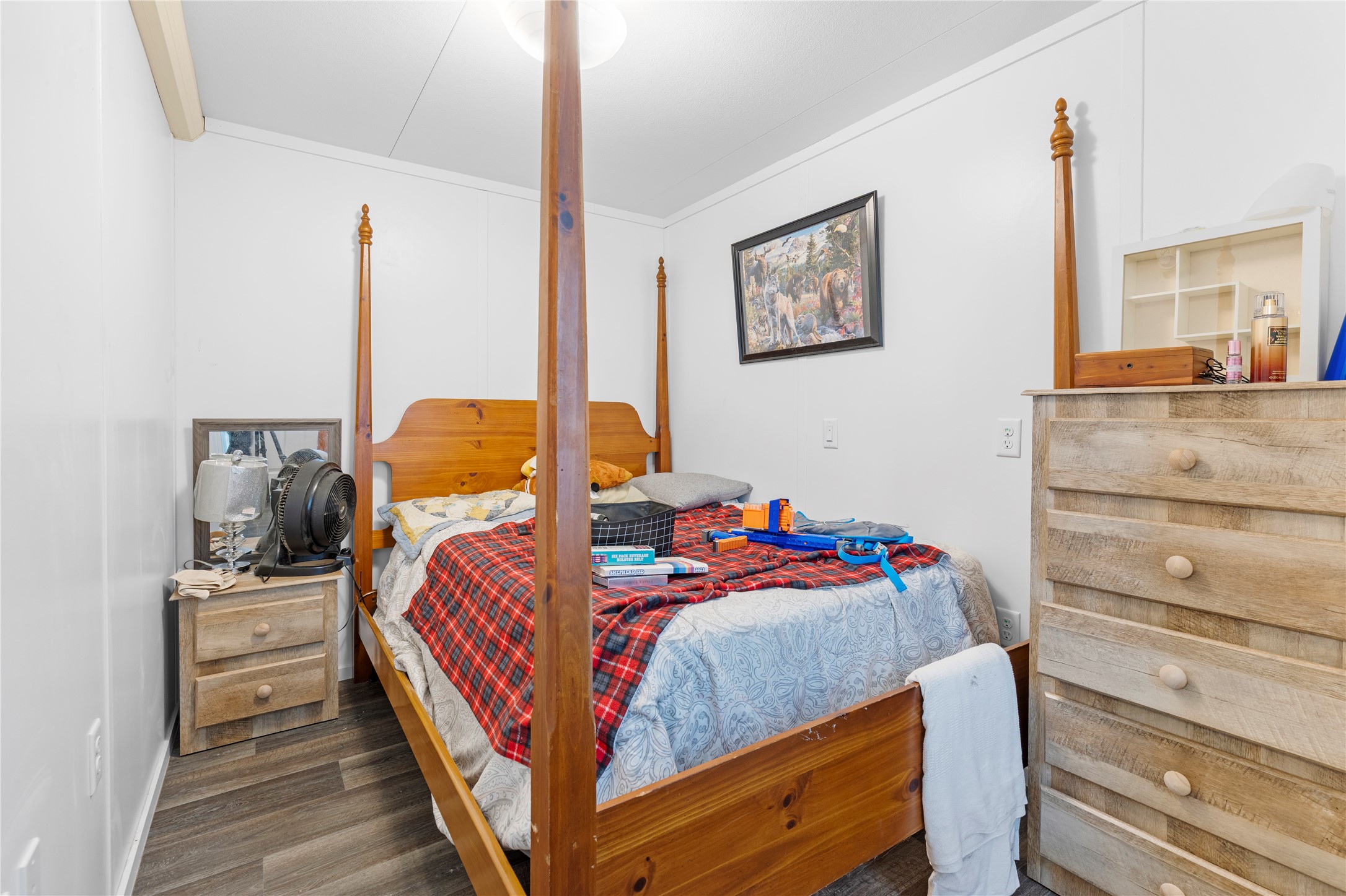 11281 Highway 150 Shepherd, TX 77371 - Photo 32 of 39 a bedroom with a bed and wooden floor