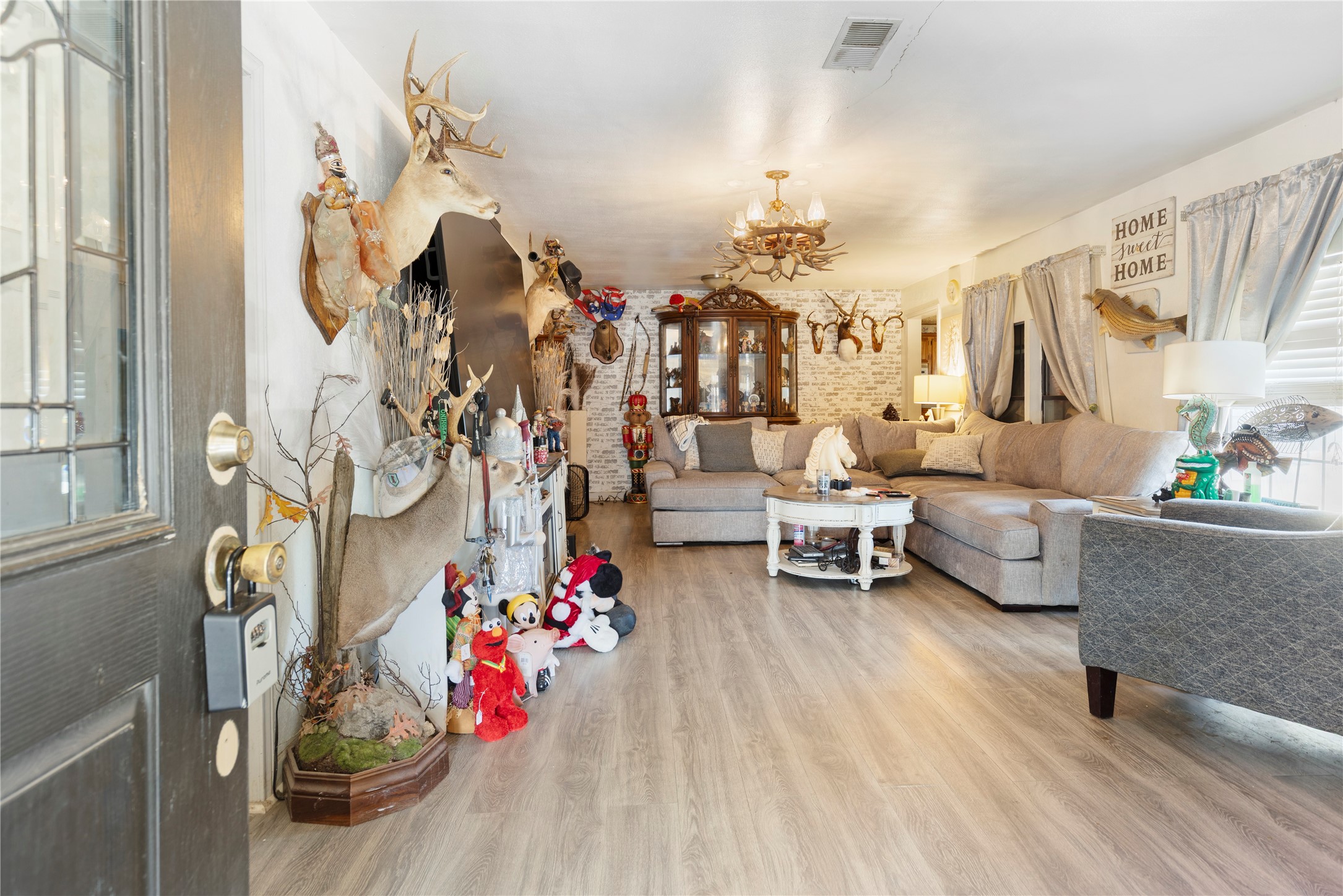 11281 Highway 150 Shepherd, TX 77371 - Photo 6 of 39 a living room with furniture and a chandelier