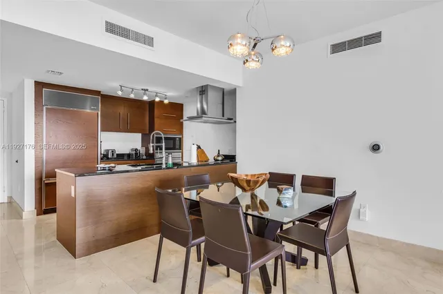 a dining room with furniture and chandelier