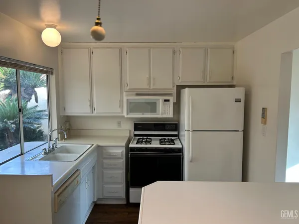 a kitchen with a sink a stove and refrigerator