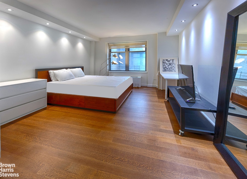 100 West 58th Street, Unit 5B Manhattan, NY 10019 - Photo 7 of 17 a spacious bedroom with a bed and window