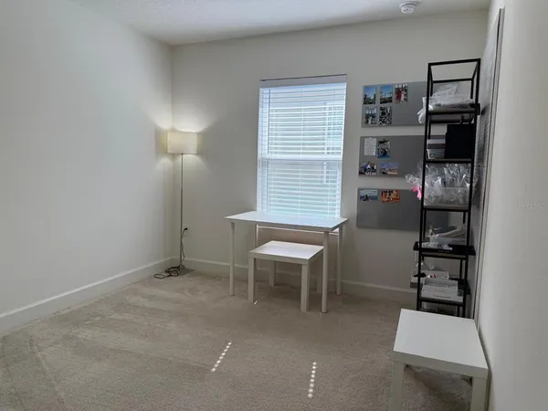 a room with furniture a lamp and a window