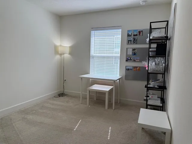 a room with furniture a lamp and a window