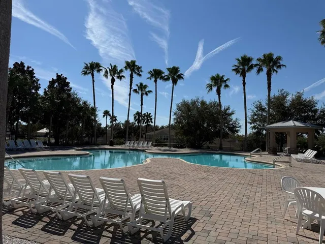 a view of a lake with a table and chairs