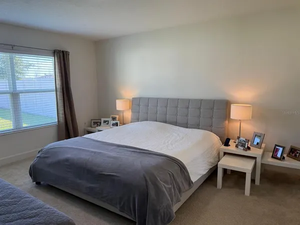 a bedroom with a bed and window