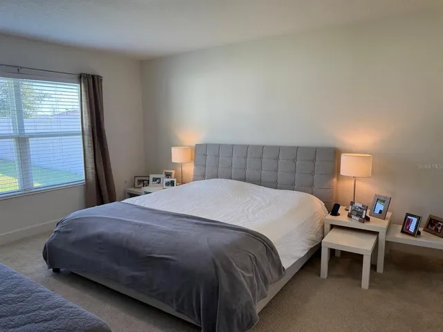 a bedroom with a bed and window