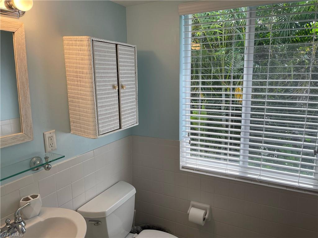 175 5th Avenue South, Unit 9 Naples, FL 34102 - Photo 6 of 19 a bathroom with a toilet a sink and a window