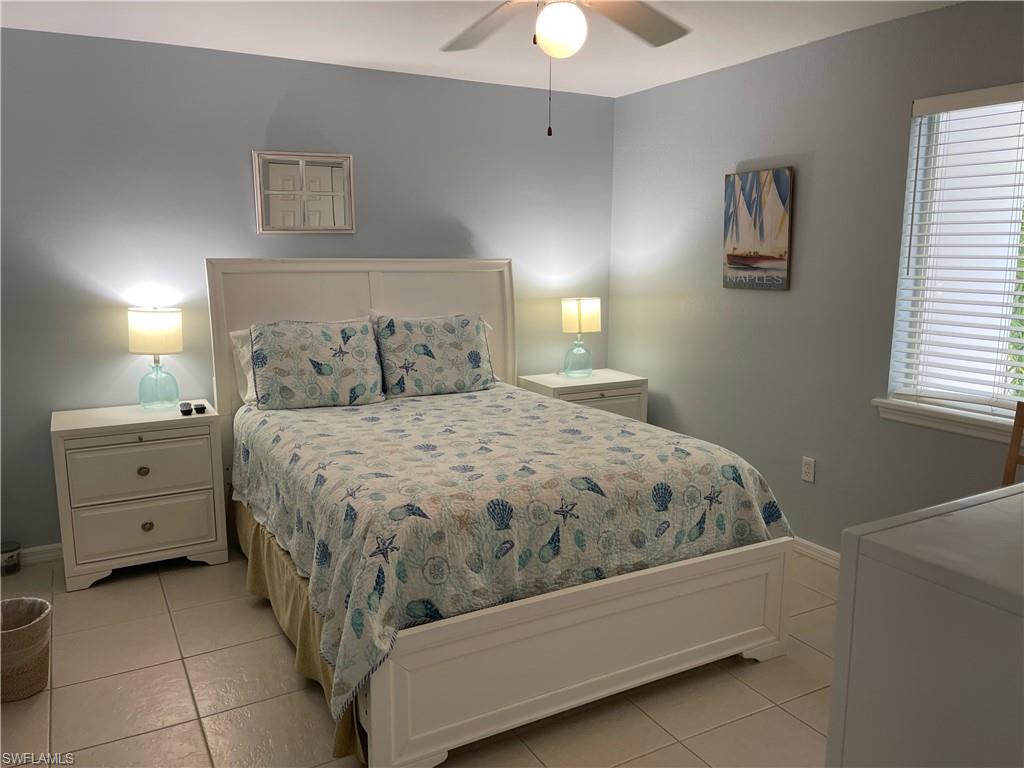 175 5th Avenue South, Unit 9 Naples, FL 34102 - Photo 7 of 19 a bedroom with a bed and a window
