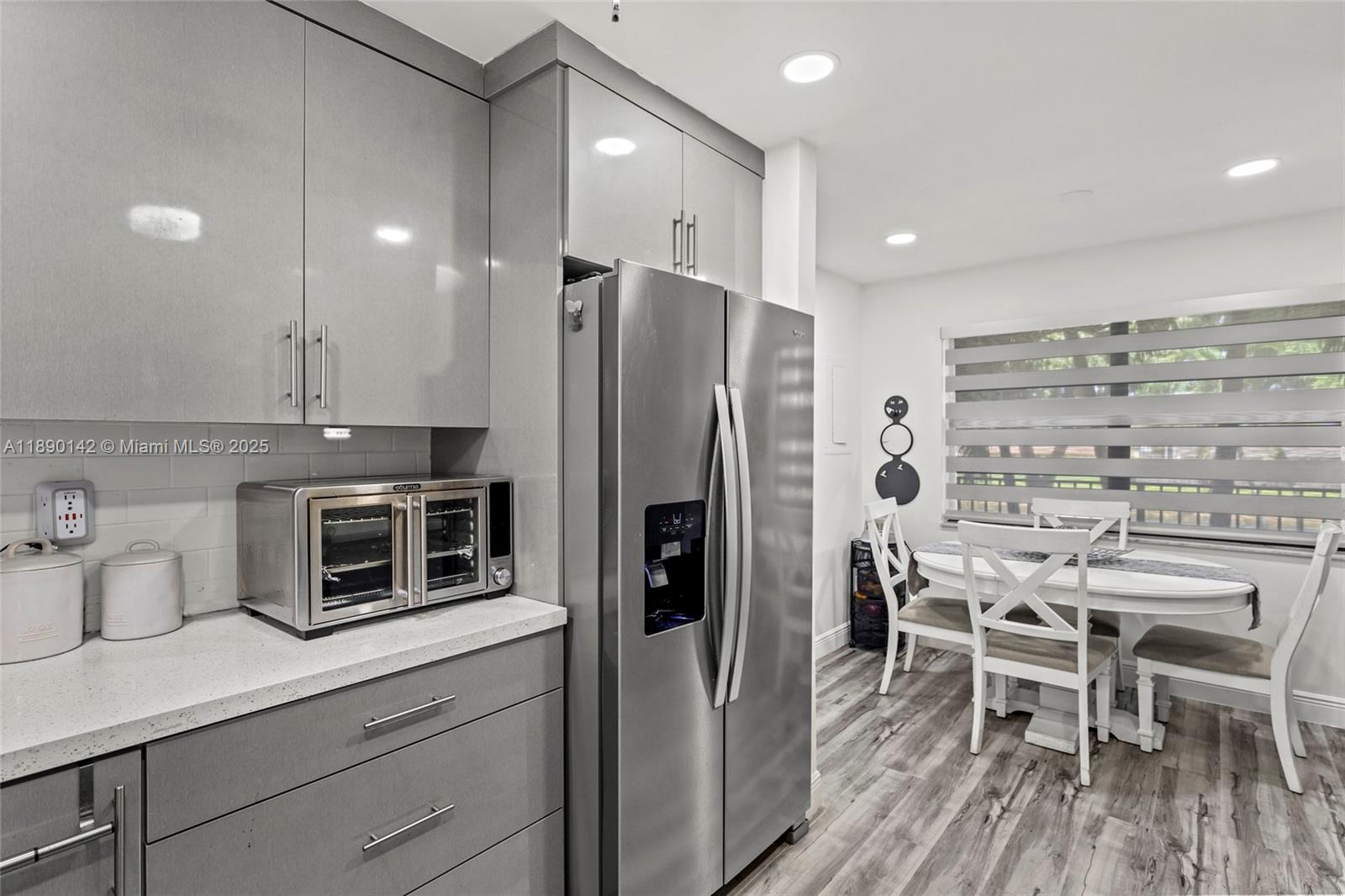 10400 Northwest 30th Court, Unit 202 Sunrise, FL 33322 - Photo 11 of 42 a kitchen with stainless steel appliances a refrigerator and a wooden cabinets